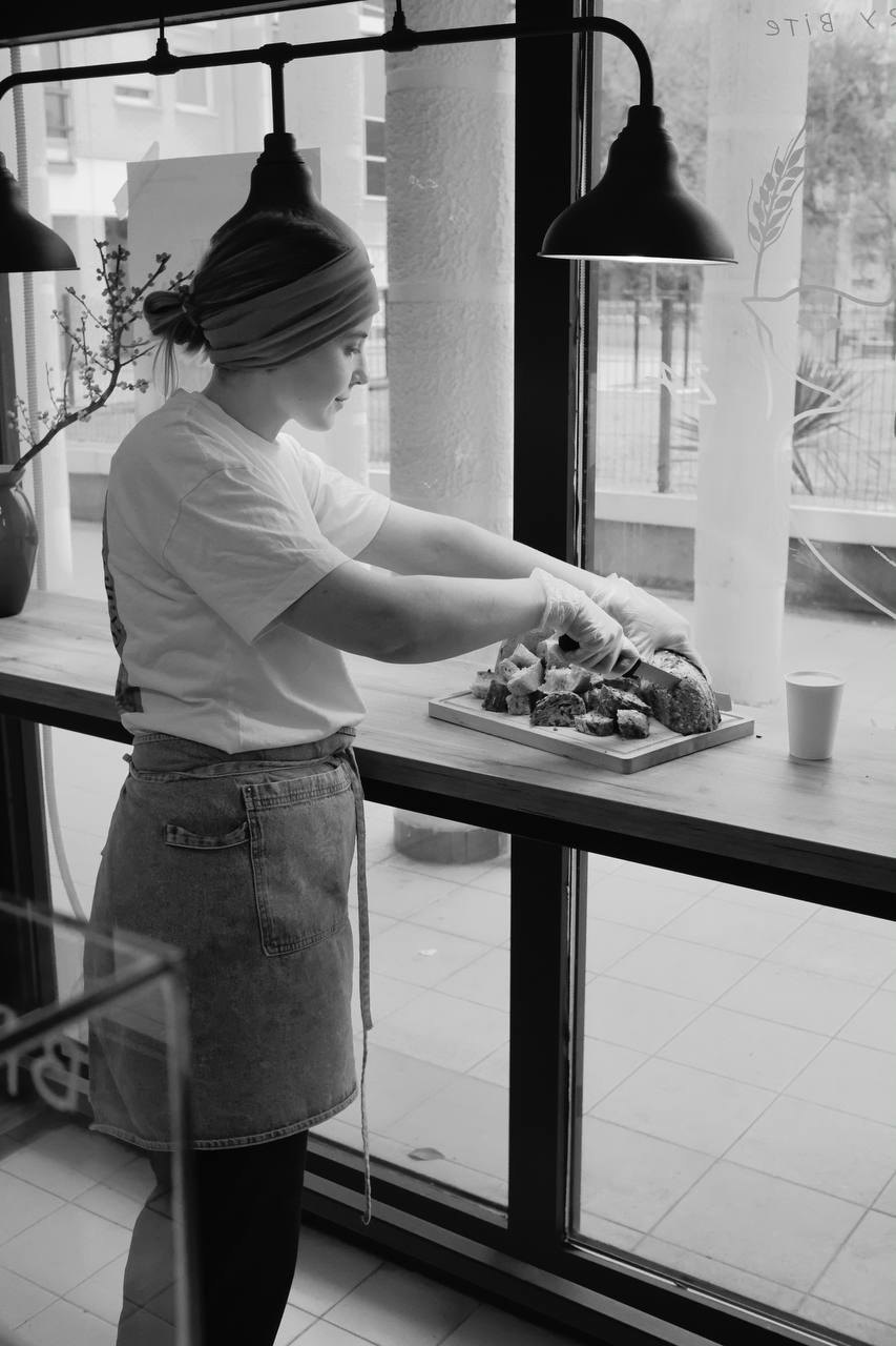 Svetlana cutting bread at the bakery counter